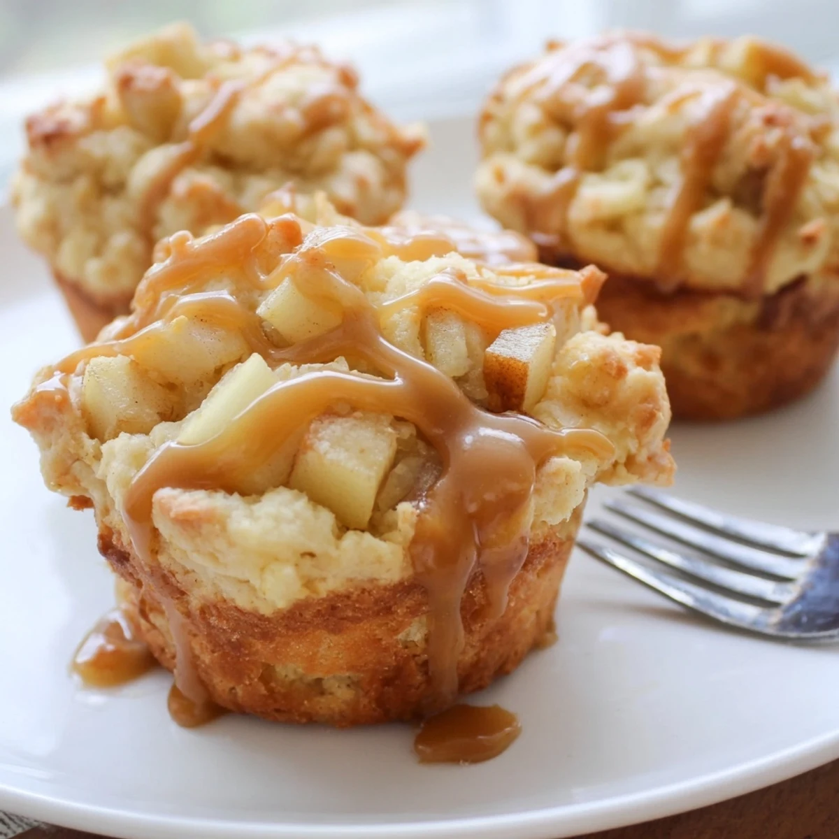 Moist caramel apple scone muffins drizzled with rich caramel glaze for breakfast delight.  