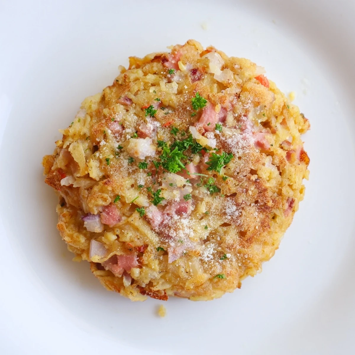 Delicious, homemade Ham & Potato Patties sizzling in a skillet, perfect for a hearty meal.