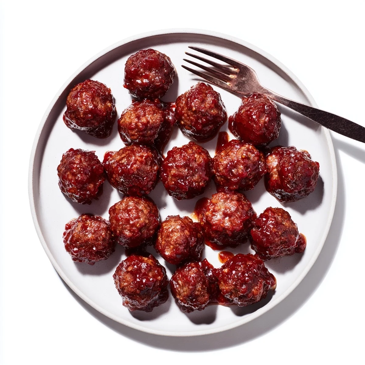 Sweet and savory cherry-glazed meatballs offer a delightful bite, perfect for snacking at potlucks.