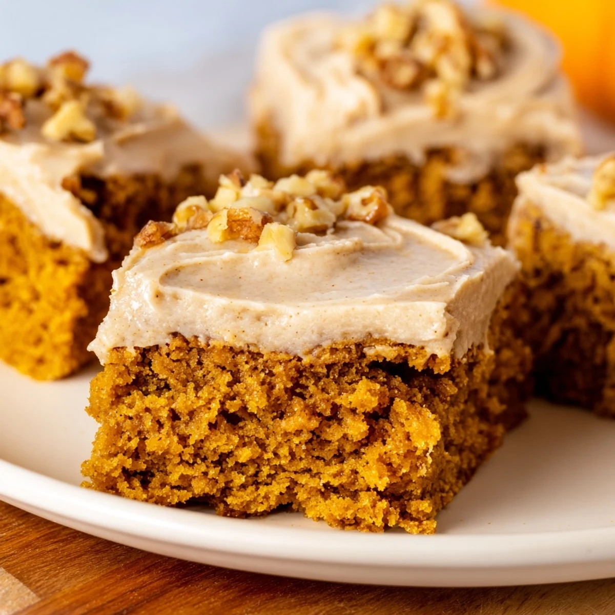 Golden-brown pumpkin bars, frosted generously with brown sugar, a perfect fall dessert.