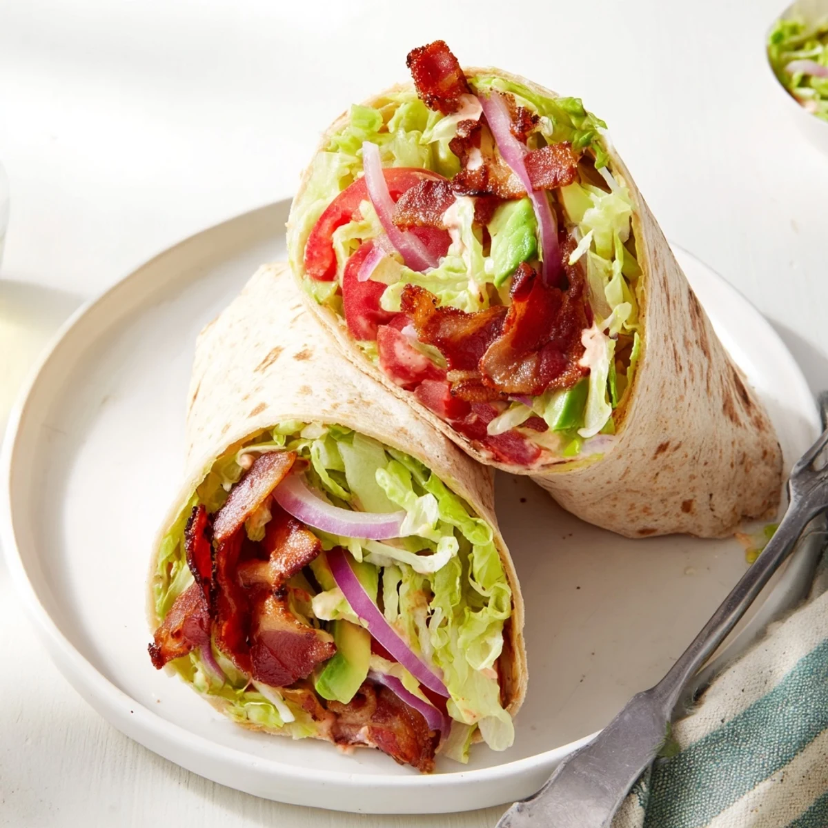 Crispy bacon and fresh veggies fill these zesty BLT wraps, enhanced with smoky chipotle mayo.