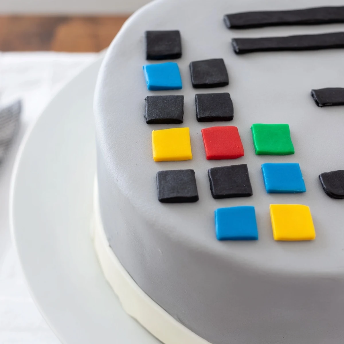 Vibrant pixelated Pixel Video Game Controller Cake, a fun dessert decorated with colorful fondant squares.