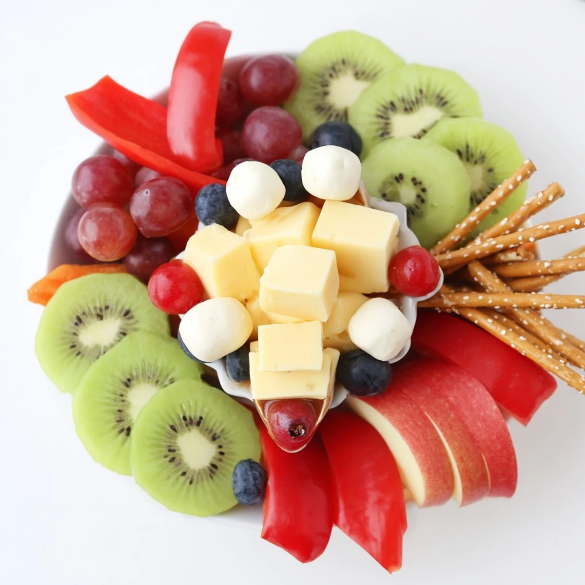 A party-ready Spaceship Launch Snack Board featuring cheese "rockets," colorful veggies and fruits, and dips.