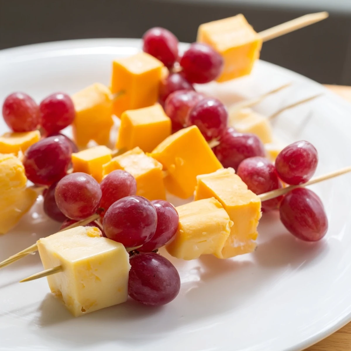 A close-up of Cheese & Grape Skewers showing perfectly paired cheese & grape bite-sized nibbles.