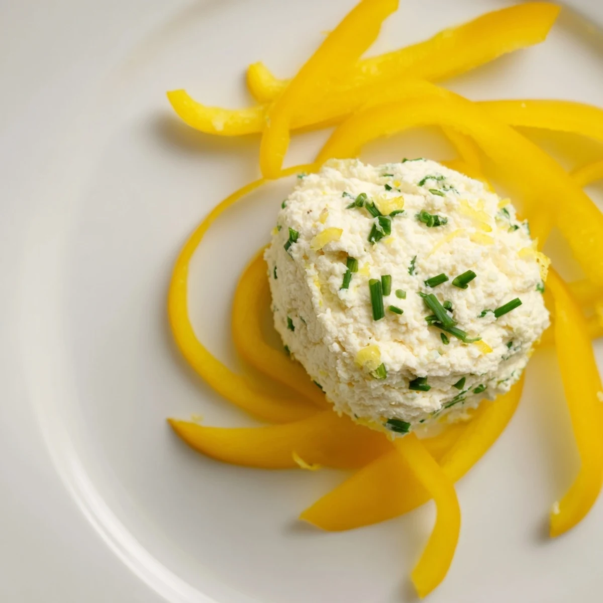 Bright, flavorful Tuscan Sunburst appetizer: sliced yellow peppers radiating from lemon-herb goat cheese. Serve with breadsticks.