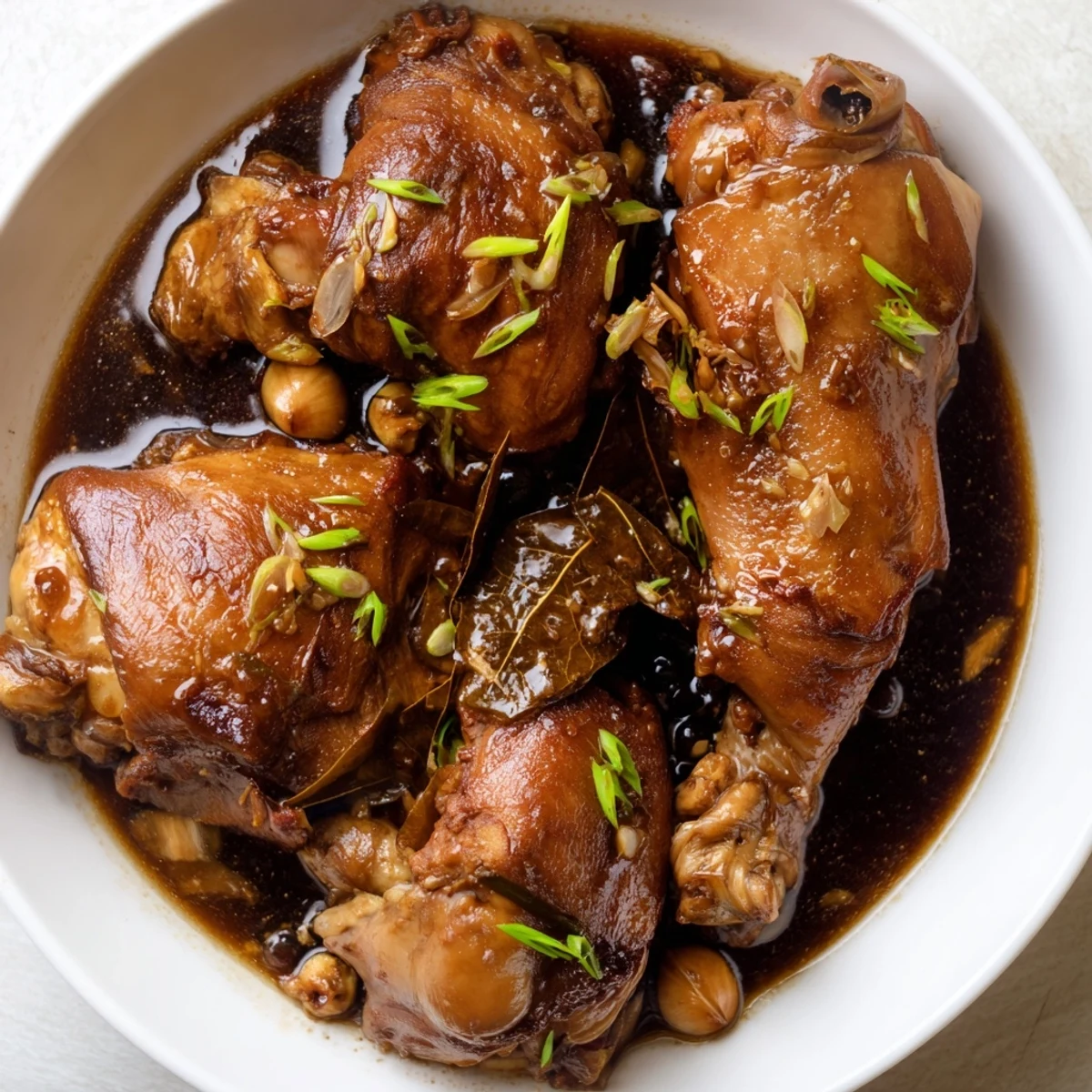 Tender Filipino Chicken Adobo with glistening sauce, perfect over fluffy white rice.