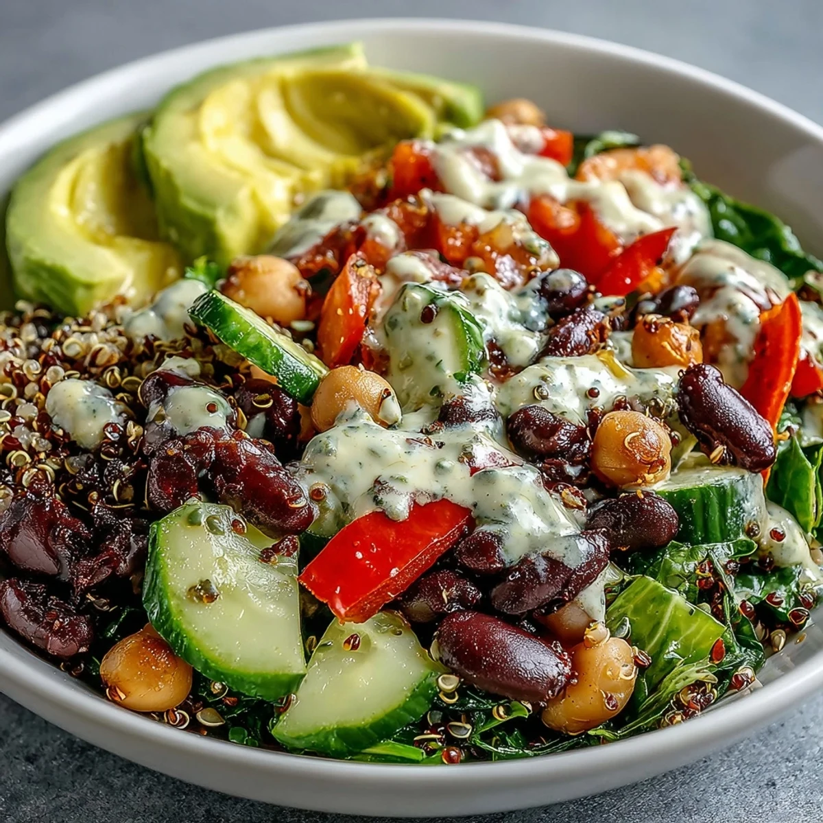 Fresh, vibrant Three-Bean Power Bowl topped with creamy avocado slices, diced bell peppers, and a zesty lemon dressing.