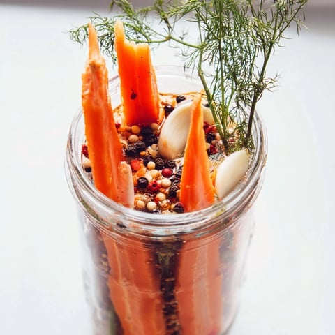 Freshly made Quick Pickled Carrot Spears, vibrant orange, ready to crunch for a tasty snack.