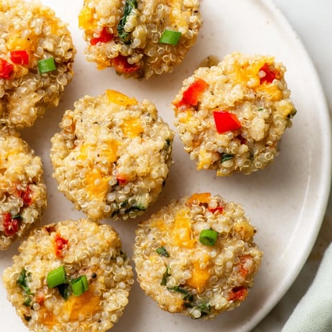 Golden-brown Baked Cheddar Quinoa Bites filled with vibrant veggies, perfect for easy, healthy snacking.