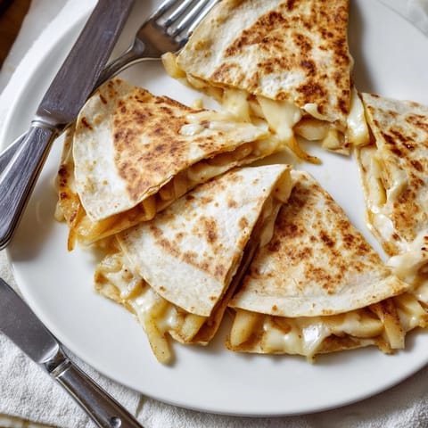 Melted cheddar and sweet apple filling pressed between toasted Cheddar Apple Quesadillas.