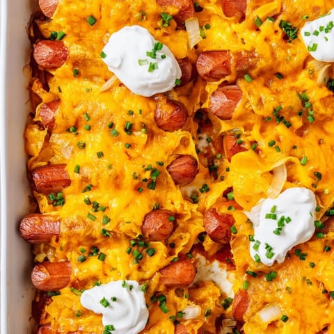 This image shows a freshly baked Chili Dog Casserole with a perfect blend of toppings and texture.