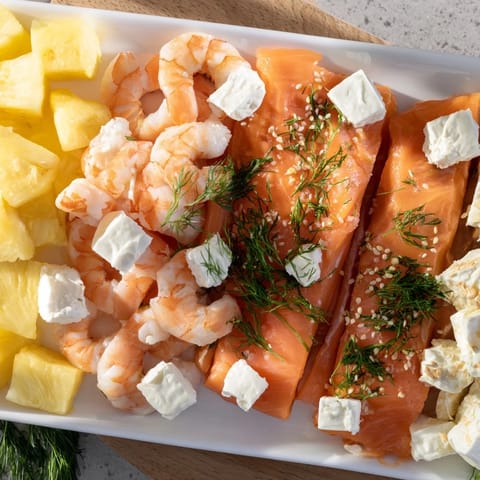 Coastal Wave Rider Surfer Snack Board featuring smoked salmon and colorful fresh fruits, a perfect shareable plate.