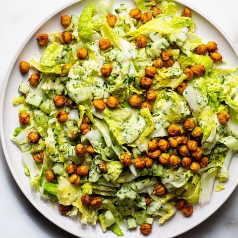This satisfying Green Goddess Salad features creamy dressing, crunchy chickpeas, and colorful fresh vegetables.