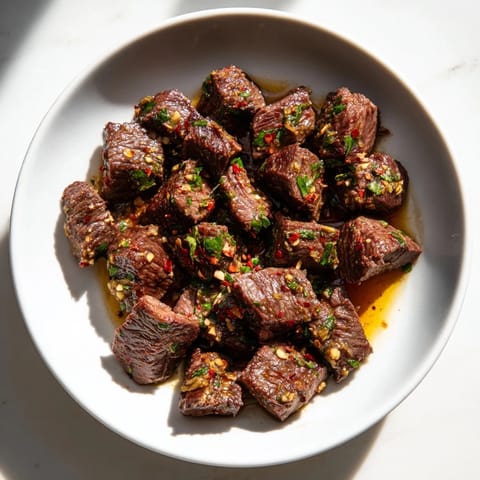 A close-up shot of tender Garlic Butter Steak Bites, garnished with fresh parsley, ready to enjoy.