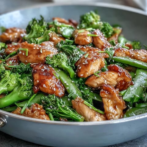 Healthy 30-minute chicken stir-fry with broccoli and snap peas in a light savory sauce.