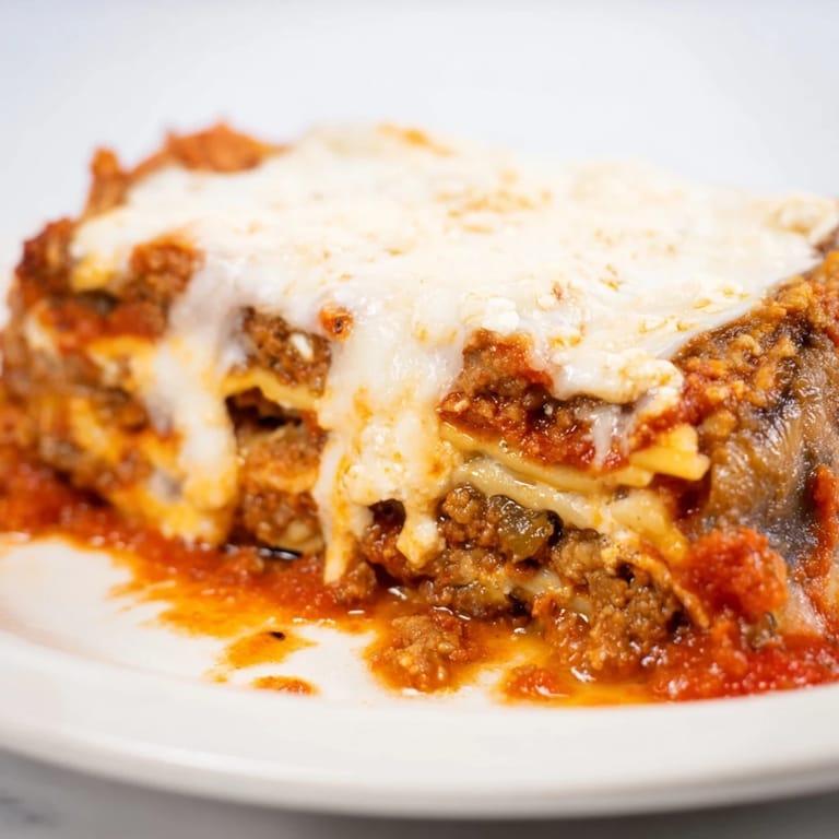 This close-up features the delicious, layered construction of homemade Eggplant Parmesan Lasagna, ready to enjoy.