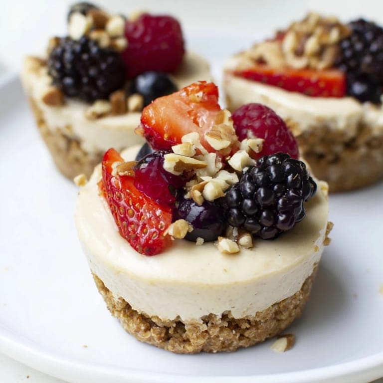 These no-bake Protein Cheesecake Cups show a smooth, white filling atop a golden crust.